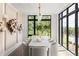 Bright dining room featuring a large window view, a long white table and seating for eight at 1131 Lupo Loop, Chattahoochee Hills, GA 30268