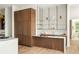 Kitchenette includes modern bar cabinet with floating shelves, sink and sleek marble countertop at 1131 Lupo Loop, Chattahoochee Hills, GA 30268