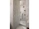 Modern walk-in shower featuring white marble walls, a rain shower head, and sleek fixtures at 1131 Lupo Loop, Chattahoochee Hills, GA 30268