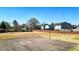 Community basketball court with painted lines, hoop, and fence surrounded by green space on a bright day at 117 Cottage Nw Walk, Cartersville, GA 30121