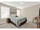 Cozy bedroom featuring a queen bed, two windows, and a sitting area at 117 Cottage Nw Walk, Cartersville, GA 30121