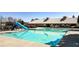 View of the bright blue community pool with slide and a clubhouse on a sunny day at 117 Cottage Nw Walk, Cartersville, GA 30121