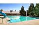 Large community pool with a slide, clear water, and a pool house in the background on a sunny day at 117 Cottage Nw Walk, Cartersville, GA 30121