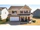 Charming two-story home features a two-car garage and a welcoming front porch with stone accents at 117 Cottage Nw Walk, Cartersville, GA 30121