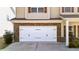 Attached two-car garage with decorative hardware and stone accents at 117 Cottage Nw Walk, Cartersville, GA 30121