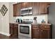 Modern kitchen featuring stainless steel appliances, granite countertops, and stylish wood cabinetry at 117 Cottage Nw Walk, Cartersville, GA 30121