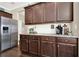 Well-equipped kitchen with stainless steel appliances, white subway tile backsplash, and wood cabinets at 117 Cottage Nw Walk, Cartersville, GA 30121
