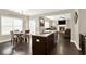 Open concept kitchen with island flowing into living and dining areas with hardwood floors and great natural light at 117 Cottage Nw Walk, Cartersville, GA 30121