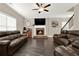 Comfortable living room with dark wood floors, leather furniture, and a stone fireplace at 117 Cottage Nw Walk, Cartersville, GA 30121