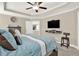 Main bedroom with a queen bed, TV, accent chair, and ensuite bathroom entrance at 117 Cottage Nw Walk, Cartersville, GA 30121