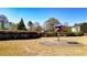 Community playground with a colorful feature set on a green lawn surrounded by trees and bushes at 117 Cottage Nw Walk, Cartersville, GA 30121