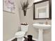 Small, stylish powder room with pedestal sink, art and decorative wall hangings at 117 Cottage Nw Walk, Cartersville, GA 30121