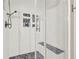 A glass shower with a built-in seat, tile surround, and a pebbled floor at 117 Cottage Nw Walk, Cartersville, GA 30121