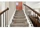 Carpeted staircase with dark wood railing and decorative stair runners at 117 Cottage Nw Walk, Cartersville, GA 30121