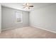 This bedroom features neutral walls, carpet, and a ceiling fan for added comfort at 12348 Hillcrest Dr, Hampton, GA 30228