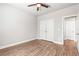 Bright bedroom featuring hardwood floors, a ceiling fan, and a closet at 12348 Hillcrest Dr, Hampton, GA 30228