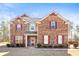 Charming brick two-story home with decorative shutters and well-manicured landscaping at 12348 Hillcrest Dr, Hampton, GA 30228