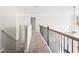 Upstairs hallway with iron railing and carpet at 12348 Hillcrest Dr, Hampton, GA 30228