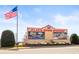 Daytime view of the entrance sign for the Atlanta Motor Speedway with an American flag waving above at 12348 Hillcrest Dr, Hampton, GA 30228