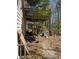 Side view of a backyard featuring a deck and discarded construction materials at 470 Yearling Dr, Loganville, GA 30052