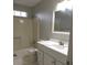 A clean bathroom with white fixtures, including a vanity and a bathtub/shower combo at 545 Haymarket Ct, Riverdale, GA 30296