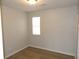 Comfortable bedroom featuring hardwood floors, neutral walls, and a bright window with blinds at 545 Haymarket Ct, Riverdale, GA 30296