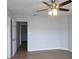 Spacious bedroom with a modern ceiling fan and easy access to another room via a doorway at 545 Haymarket Ct, Riverdale, GA 30296