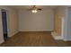 Open-concept living room with neutral paint, ceiling fan, fireplace and laminate flooring at 545 Haymarket Ct, Riverdale, GA 30296