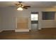 Living room featuring laminate floors, a ceiling fan and view into an adjacent room at 545 Haymarket Ct, Riverdale, GA 30296