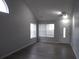 Bright living room featuring wood-look floors, a vaulted ceiling and ample natural light at 545 Haymarket Ct, Riverdale, GA 30296