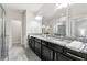 Luxurious bathroom featuring dual sinks, granite countertops, and a walk-in shower with glass door at 2474 Norwood Park Xing, Atlanta, GA 30340