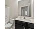 Bright bathroom featuring a shower-tub, vanity with white countertops, and a large mirror at 2474 Norwood Park Xing, Atlanta, GA 30340