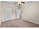 Bedroom featuring carpeted floors, a ceiling fan with lighting, and a closet at 2474 Norwood Park Xing, Atlanta, GA 30340