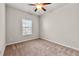 Neutral bedroom featuring carpeted floors, a ceiling fan with lighting, and a window at 2474 Norwood Park Xing, Atlanta, GA 30340