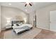 Comfortable bedroom with a gray upholstered bed, soft lighting, and a ceiling fan at 2474 Norwood Park Xing, Atlanta, GA 30340