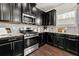 Stylish kitchen with stainless steel oven, subway tile backsplash and dark cabinets at 2474 Norwood Park Xing, Atlanta, GA 30340