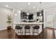 Modern kitchen features dark cabinetry, stainless steel appliances, and a granite countertop island with seating at 2474 Norwood Park Xing, Atlanta, GA 30340