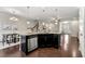 Bright and airy kitchen with granite island, stainless steel appliances and dark cabinets at 2474 Norwood Park Xing, Atlanta, GA 30340