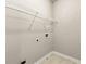 The laundry room featuring tile floors, wire shelving, and washer/dryer hookups at 2474 Norwood Park Xing, Atlanta, GA 30340