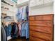 Closet with custom shelving and racks for hanging clothes, features a wooden dresser at 5980 Mallet Ct, Cumming, GA 30040