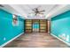 Finished basement with blue walls, wood-look flooring, recessed lighting, and a custom shelving unit at 930 Camden Hill Ct, Lawrenceville, GA 30046
