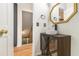 Stylish powder room featuring vessel sink, industrial vanity, gold mirror, and unique decor at 930 Camden Hill Ct, Lawrenceville, GA 30046