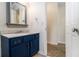 Charming bathroom featuring a vanity with a marble countertop and decorative blue cabinets at 930 Camden Hill Ct, Lawrenceville, GA 30046