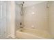 Bright bathroom featuring a standard bathtub with shower at 930 Camden Hill Ct, Lawrenceville, GA 30046