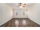 Bright bedroom features ceiling fan, two windows, neutral paint and wood-look flooring at 930 Camden Hill Ct, Lawrenceville, GA 30046