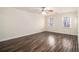 Spacious bedroom with hardwood-style floors, neutral walls, two windows and modern ceiling fan at 930 Camden Hill Ct, Lawrenceville, GA 30046
