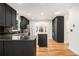 Modern kitchen with sleek black cabinets, stainless steel appliances, and a center island at 930 Camden Hill Ct, Lawrenceville, GA 30046