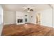 Open living room with hardwood floors and a cozy fireplace at 930 Camden Hill Ct, Lawrenceville, GA 30046