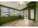 Enclosed porch area featuring wood flooring, and backyard views at 930 Camden Hill Ct, Lawrenceville, GA 30046