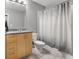 Bathroom features a granite countertop vanity and a shower/tub with a decorative shower curtain at 943 Peachtree Ne St # 1603, Atlanta, GA 30309